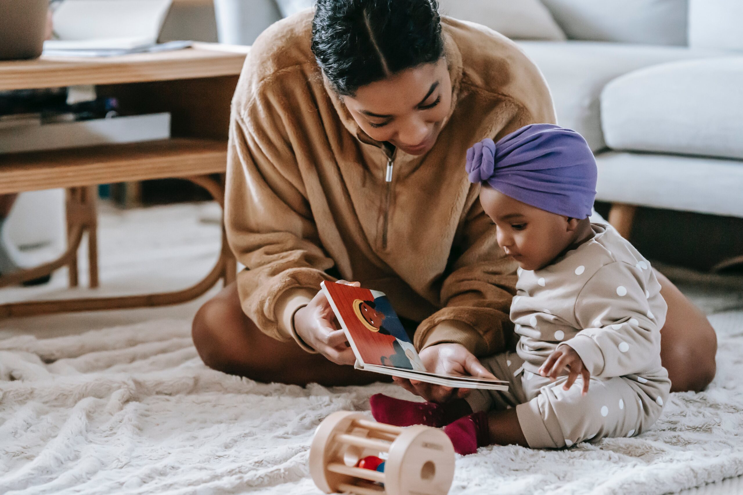 women and child reading together on the floor